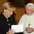 File photo of German Chancellor Angela Merkel smiling while visiting Pope Benedict XVI at the Vatican