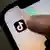 A teenager clicks on the TikTok icon on their smartphone